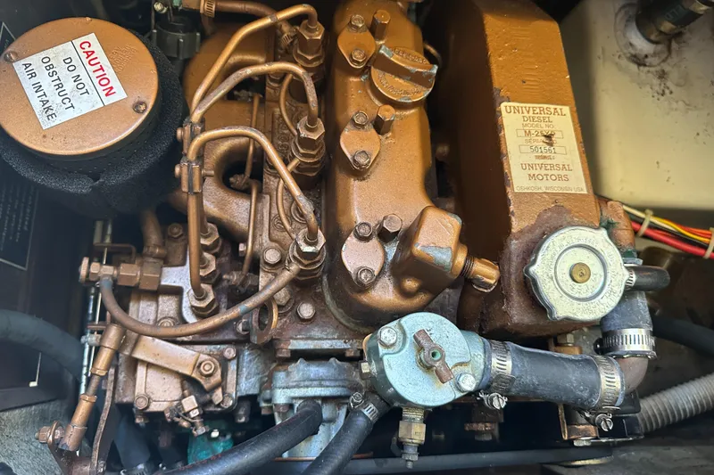 Slide: The Image of Catalina 30 1988 engine, Universal model, detailed view of components and air intake. - 13