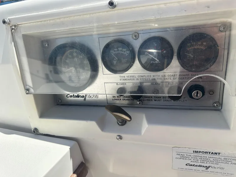 Slide: The Image of Dashboard of a 1988 Catalina 30 yacht with gauges and controls. - 16