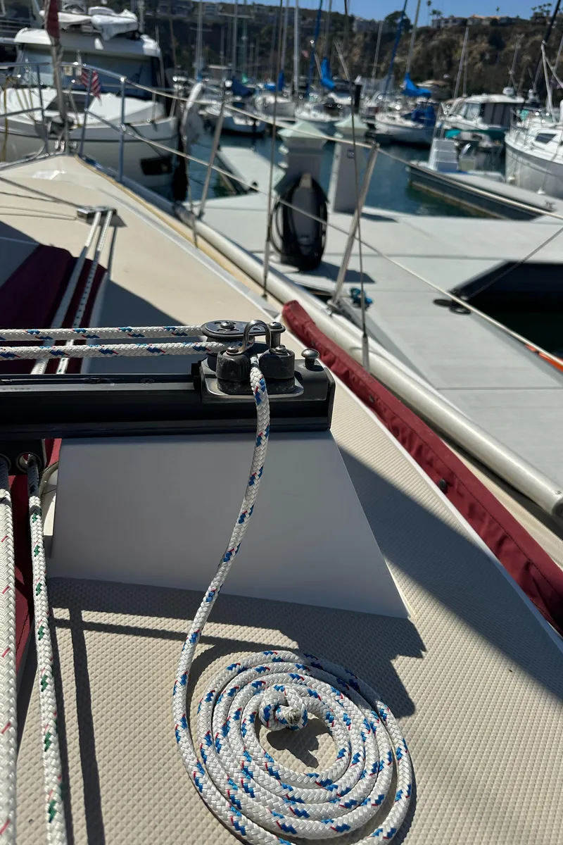 Slide: The Image of 1988 Catalina 30 sailboat deck with ropes in a marina setting. - 23