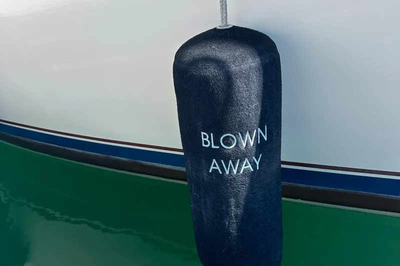 Slide: The Image of Boat fender with "Blown Away" text on Catalina 30, 1988 model. - 29