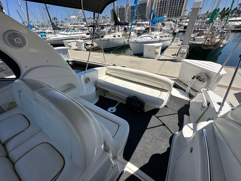 Slide: The Image of 2003 Sea Ray SUNDANCER 300 interior with white seating, docked at marina. - 15