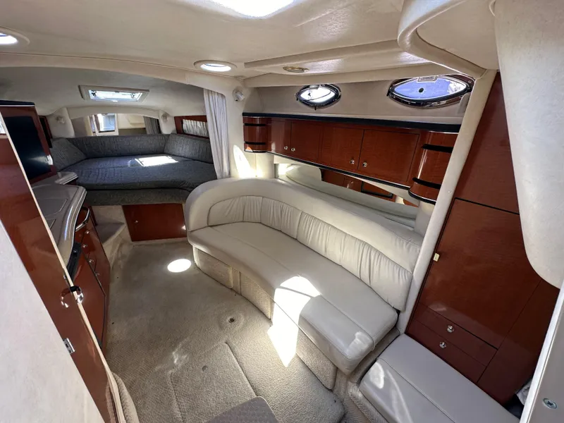 Slide: The Image of Interior of 2003 Sea Ray SUNDANCER 300 yacht with plush seating and wood cabinetry. - 16