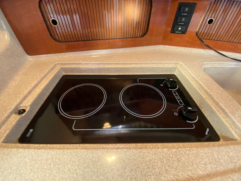Slide: The Image of Stovetop in 2003 Sea Ray SUNDANCER 300 yacht kitchen, featuring dual burners and sleek design. - 22