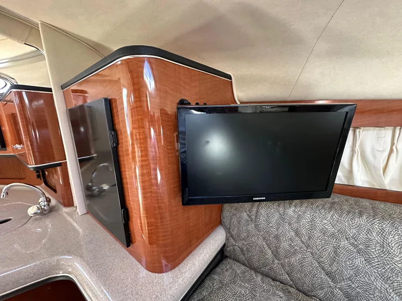 Slide: The Image of Interior of 2003 Sea Ray SUNDANCER 300 with TV and wood cabinetry. - 26