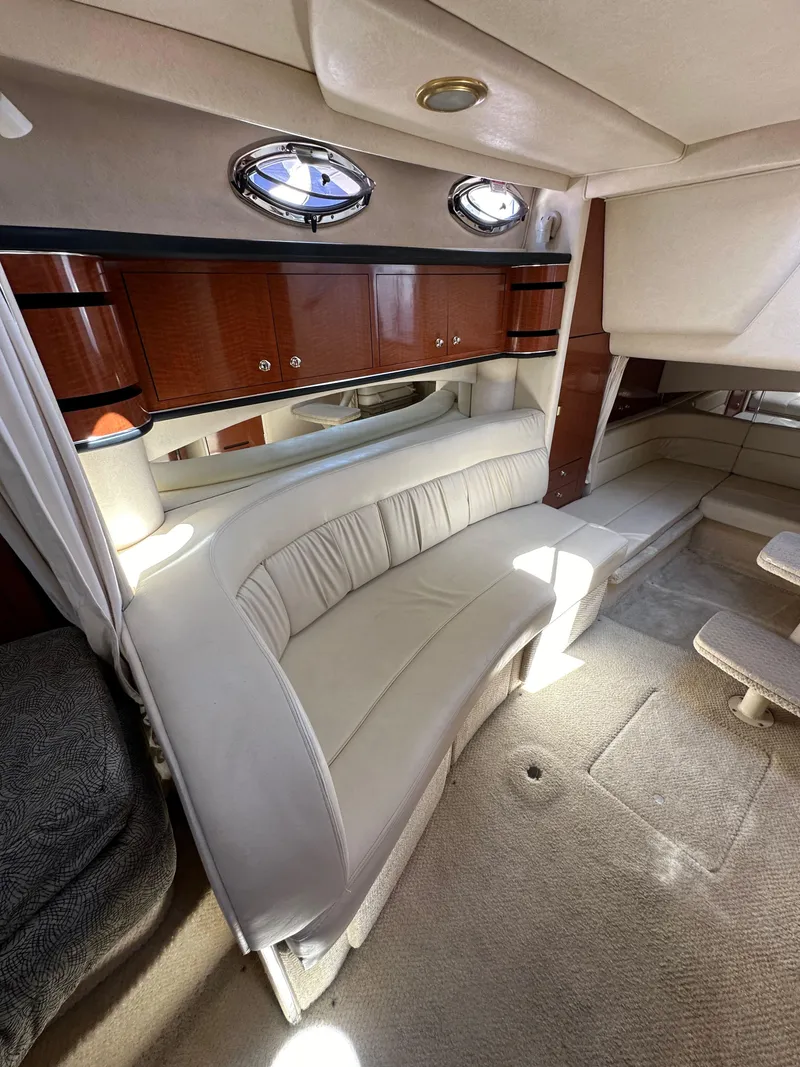 Slide: The Image of Interior of 2003 Sea Ray SUNDANCER 300 yacht with plush seating and elegant wood cabinetry. - 28