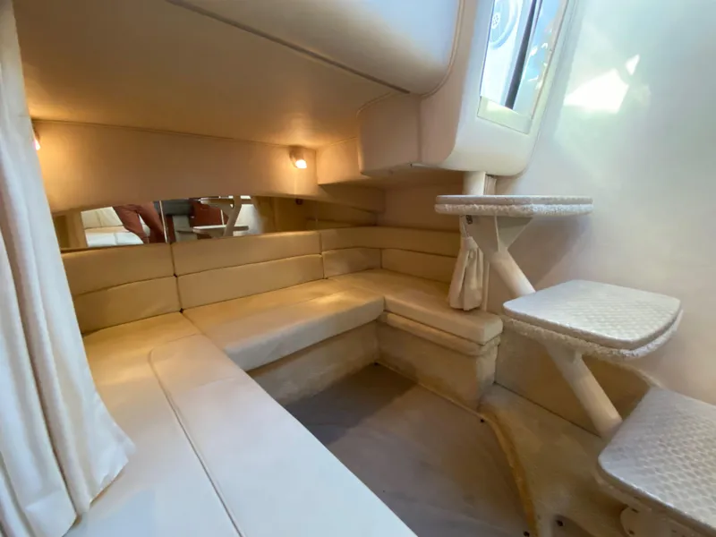 Slide: The Image of Interior of 2003 Sea Ray SUNDANCER 300, featuring beige seating and compact design. - 32
