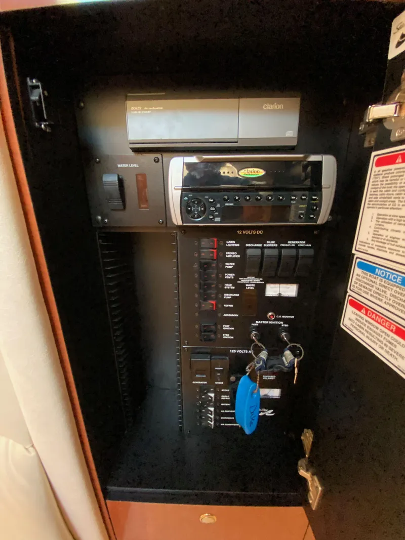 Slide: The Image of Electrical panel inside a 2003 Sea Ray SUNDANCER 300 boat, featuring various controls and keys. - 34