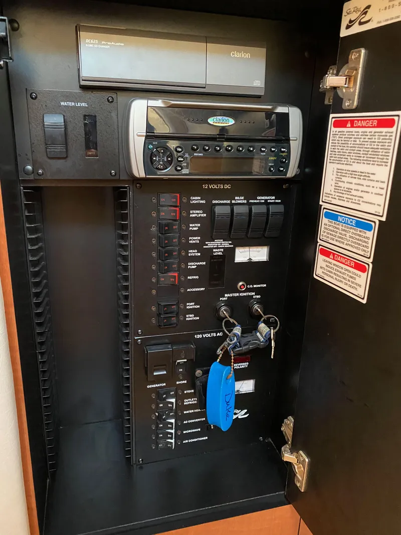 Slide: The Image of Electrical panel of a 2003 Sea Ray SUNDANCER 300 boat with control switches and labels. - 35