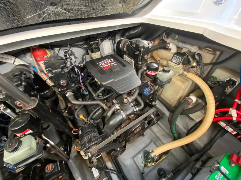 Slide: The Image of Engine compartment of a 2003 Sea Ray SUNDANCER 300 boat, featuring a 350 MAG MPI engine. - 47