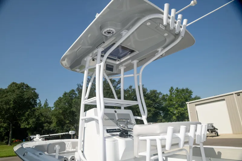 Slide: The Image of 2025 Contender 26 Bay boat with T-top and console, outdoors on a sunny day. - 11