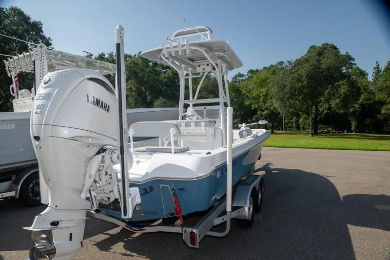 Slide: The Image of 2025 Contender 26 Bay boat with Yamaha engine on trailer, parked outdoors. - 2