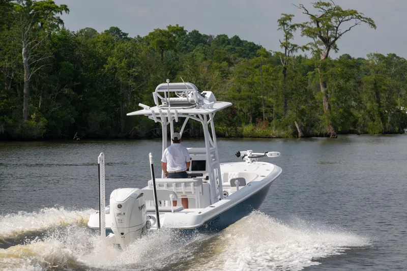 Slide: The Image of 2025 Contender 26 Bay boat cruising on a scenic river. - 23