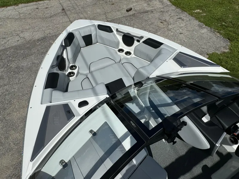 Slide: The Image of 2022 Malibu Wakesetter 20 VTX boat interior with sleek seating and cup holders. - 13