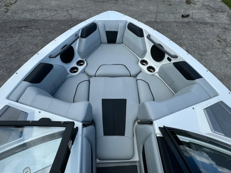 Slide: The Image of 2022 Malibu Wakesetter 20 VTX boat interior with gray seating and cup holders. - 14