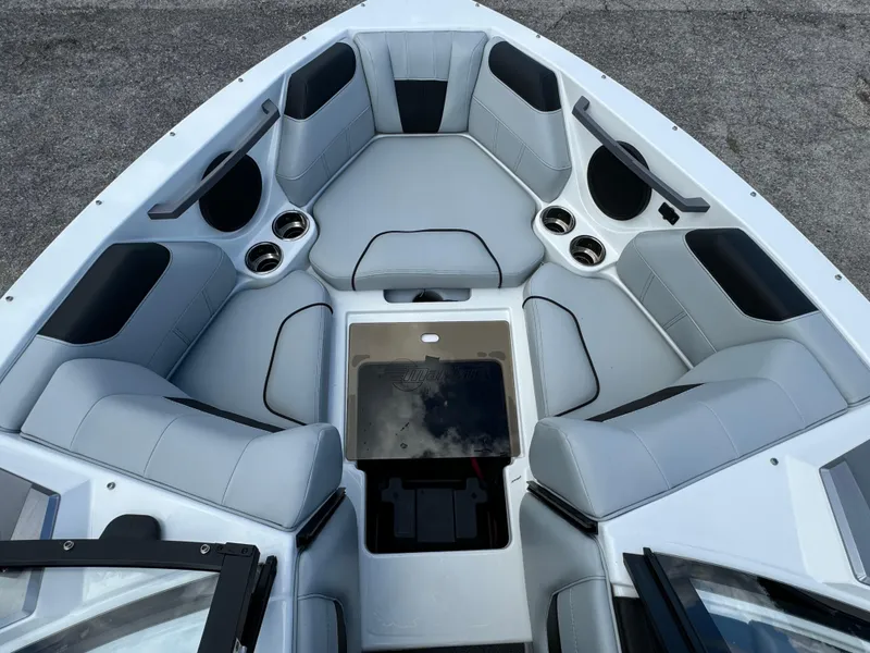 Slide: The Image of 2022 Malibu Wakesetter 20 VTX boat interior with gray seating and cup holders. - 15
