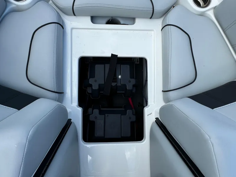 Slide: The Image of 2022 Malibu Wakesetter 20 VTX boat battery compartment with white seating. - 16