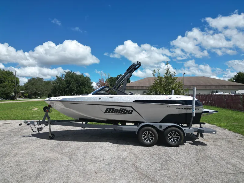 Slide: The Image of 2022 Malibu Wakesetter 20 VTX boat on trailer under blue sky. - 2