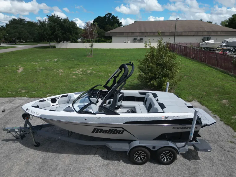 Slide: The Image of 2022 Malibu Wakesetter 20 VTX boat on trailer, parked outdoors. - 3