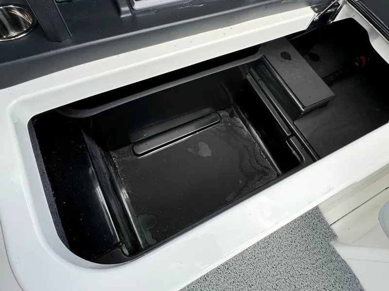 Slide: The Image of 2022 Malibu Wakesetter 20 VTX storage compartment, black interior, open lid. - 40