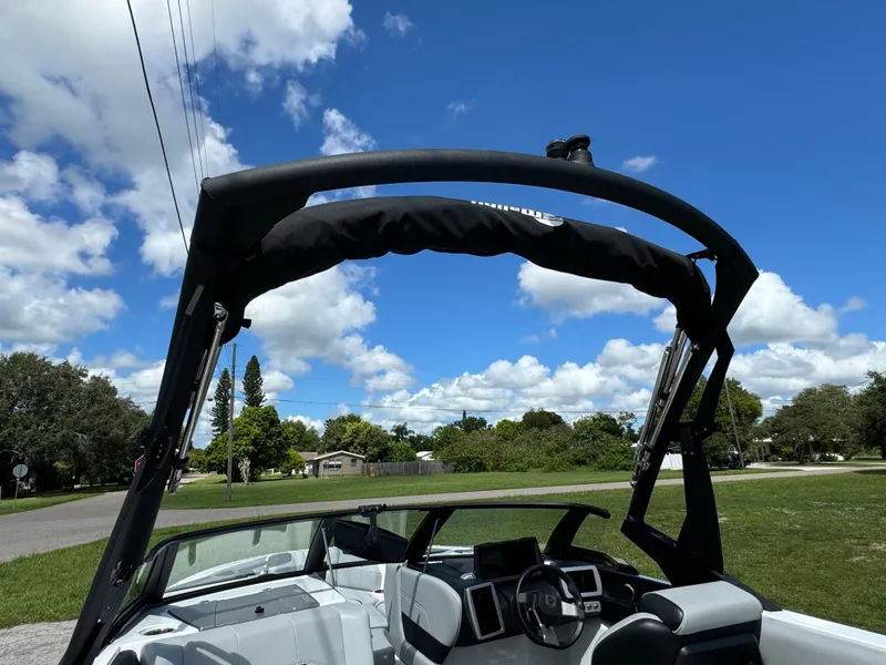 Slide: The Image of 2022 Malibu Wakesetter 20 VTX boat with wakeboard tower under blue sky. - 45