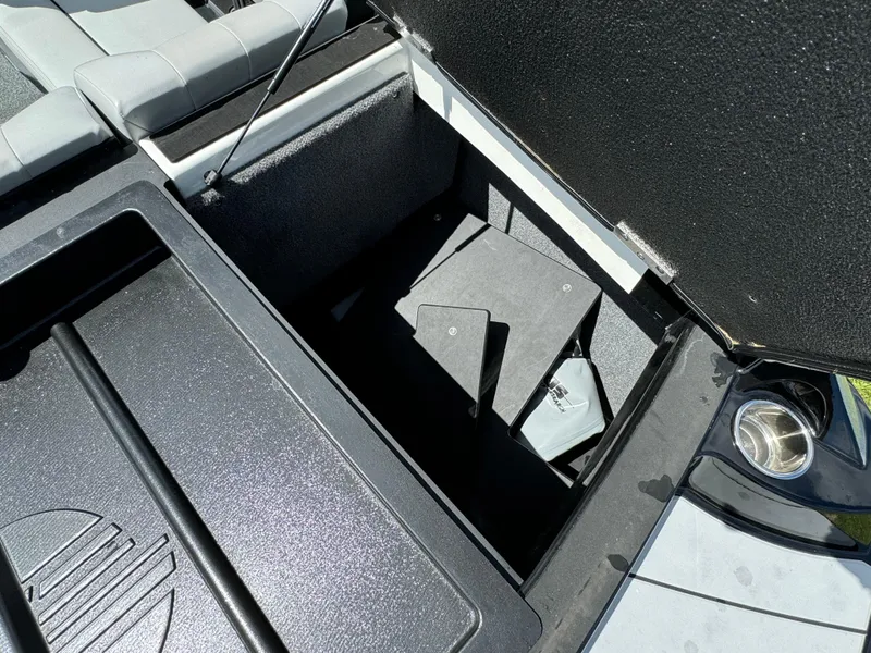 Slide: The Image of 2022 Malibu Wakesetter 20 VTX storage compartment with open lid, showcasing interior space. - 48