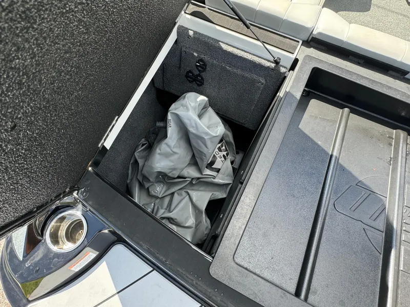 Slide: The Image of 2022 Malibu Wakesetter 20 VTX storage compartment with cover and accessories. - 49