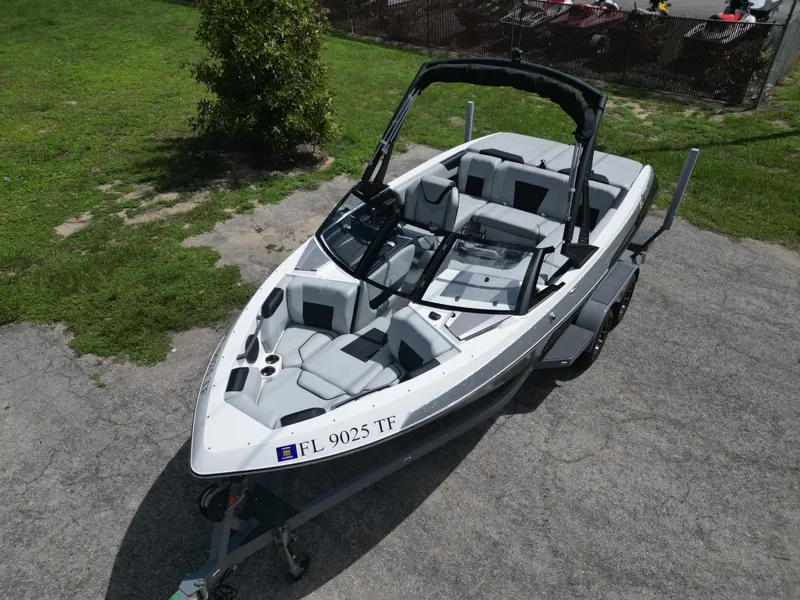 Slide: The Image of 2022 Malibu Wakesetter 20 VTX boat on trailer, parked on pavement. - 9
