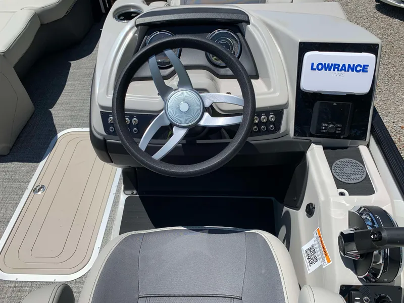 Slide: The Image of 2025 Barletta Cabrio 20UC boat dashboard with steering wheel and Lowrance display. - 11