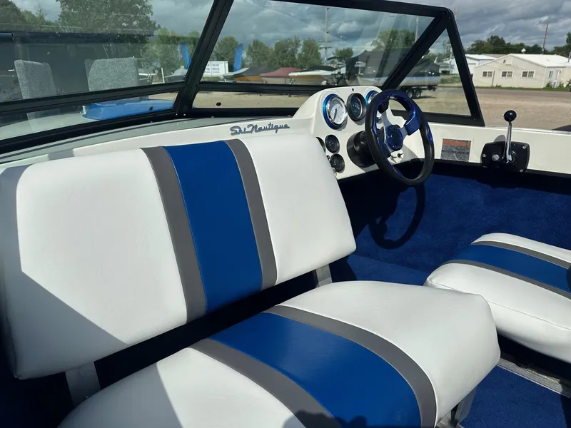 Slide: The Image of 1977 Correct Craft Ski Nautique interior with blue and white seats and dashboard. - 12