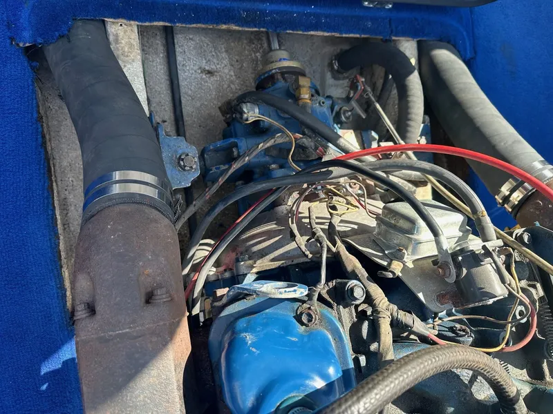 Slide: The Image of 1977 Correct Craft Ski Nautique engine with blue components and wiring. - 19