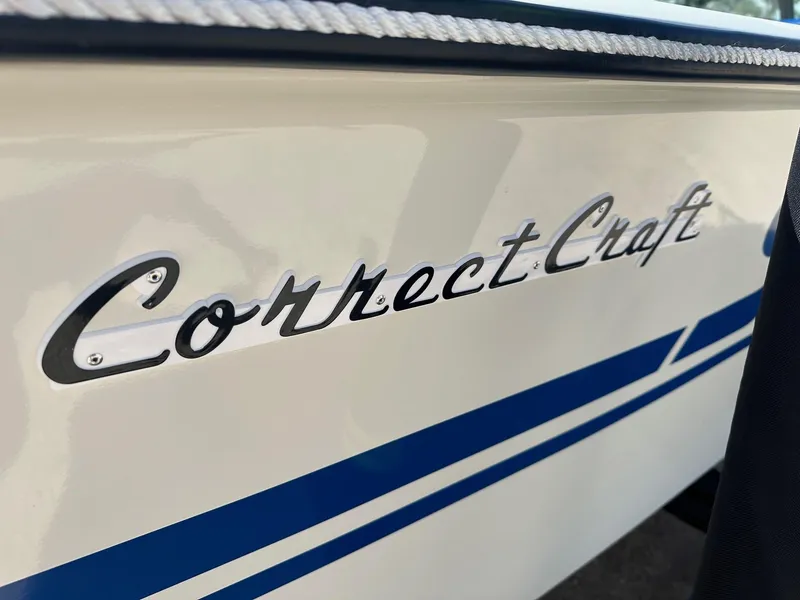 Slide: The Image of 1977 Correct Craft Ski Nautique boat with blue stripes and logo detail. - 3
