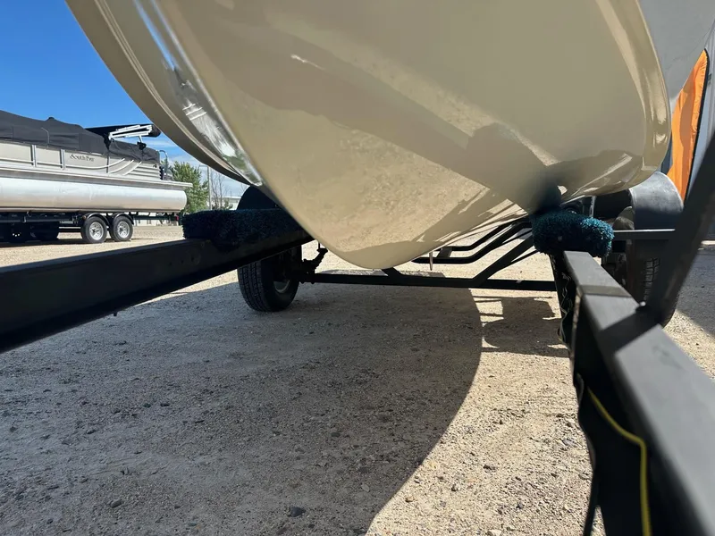 Slide: The Image of 1977 Correct Craft Ski Nautique on trailer, underside view, parked on gravel. - 6