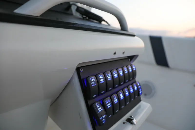 Slide: The Image of Control panel of a 2008 Midnight Express 37 boat with illuminated switches. - 10