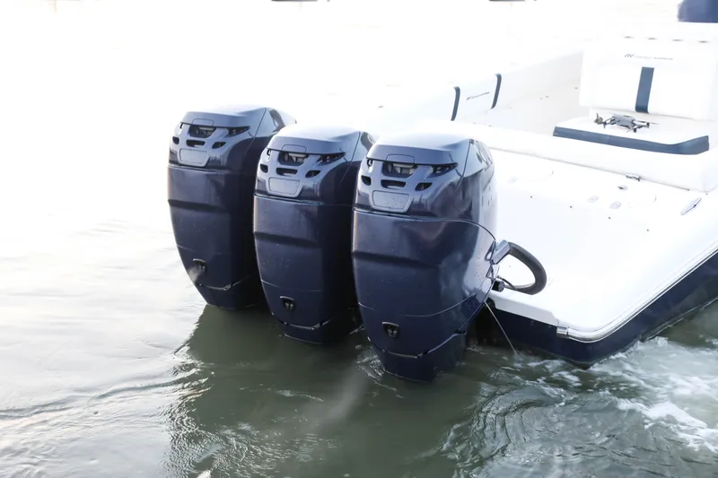 Slide: The Image of 2008 Midnight Express 37 boat with triple outboard engines in water. - 12
