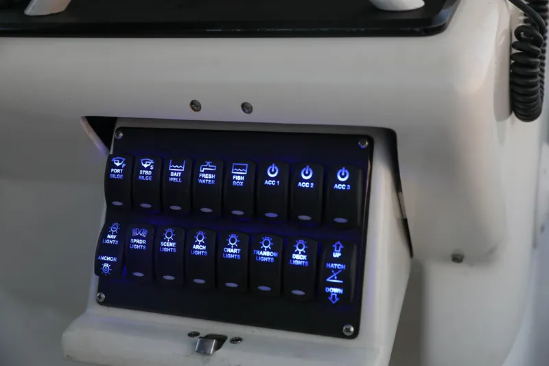 Slide: The Image of Control panel of a 2008 Midnight Express 37 boat with illuminated switches. - 13