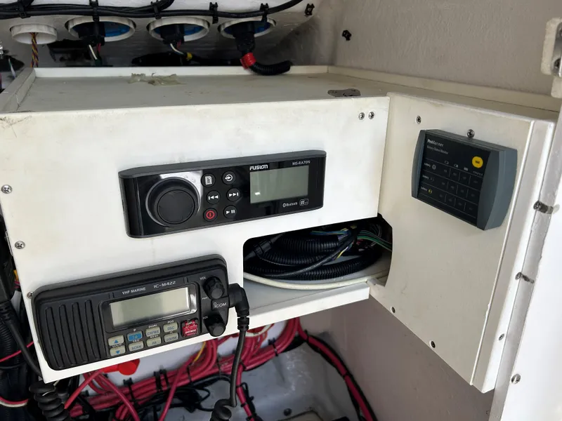 Slide: The Image of 2008 Midnight Express 37 boat electronics panel with radio and control systems. - 15