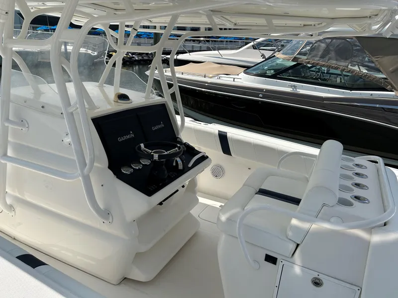 Slide: The Image of 2008 Midnight Express 37 boat cockpit with steering wheel and seating. - 17