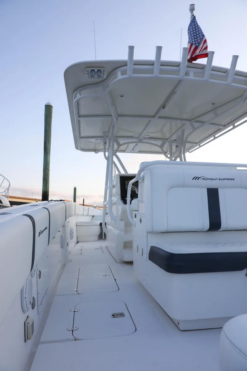 Slide: The Image of 2008 Midnight Express 37 boat interior with seating and American flag. - 20
