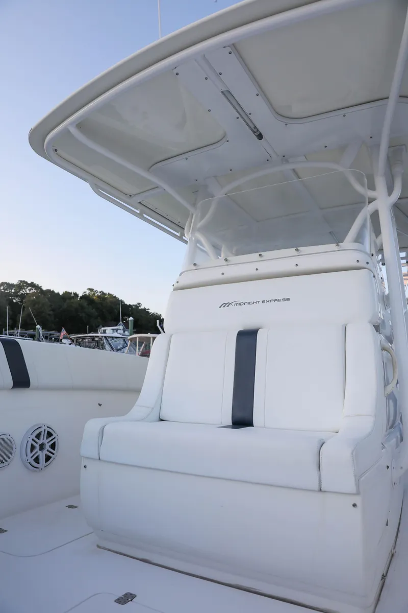 Slide: The Image of 2008 Midnight Express 37 boat with white seating and canopy. - 21