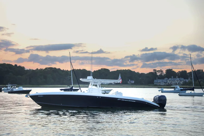 Slide: The Image of 2008 Midnight Express 37 boat on calm water at sunset. - 24