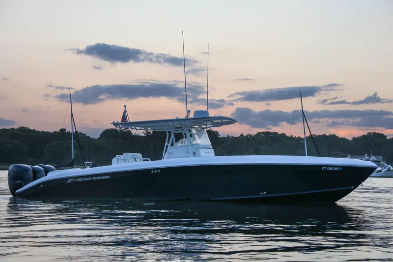 Slide: The Image of 2008 Midnight Express 37 boat on calm water at sunset. - 25