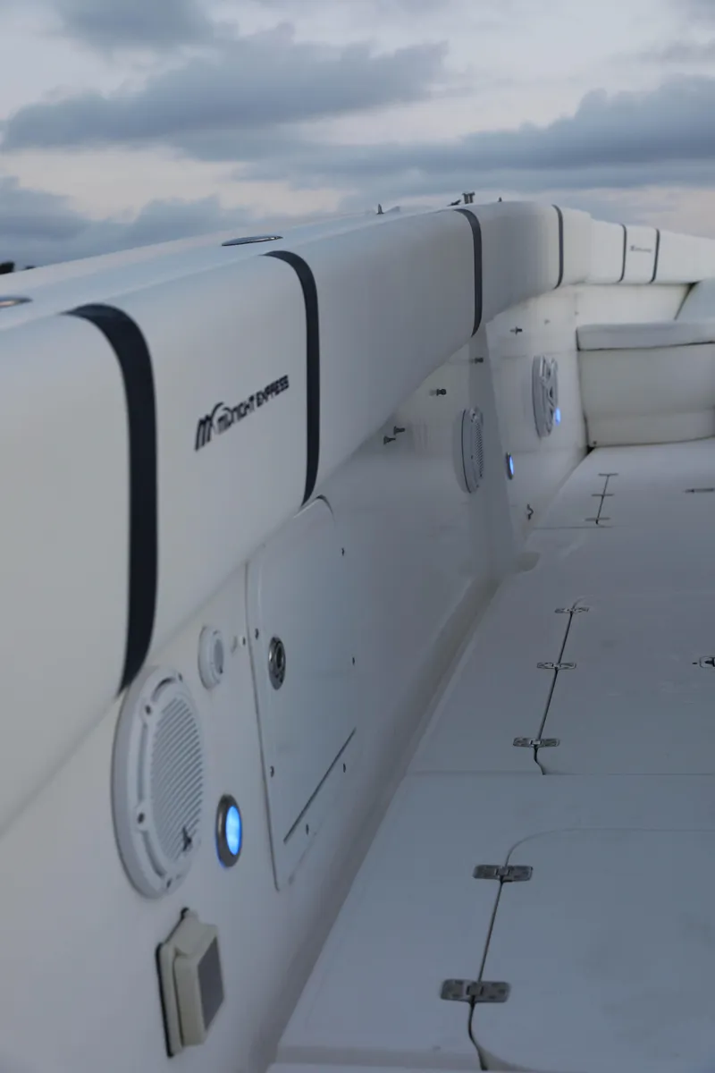 Slide: The Image of 2008 Midnight Express 37 boat interior with white seating and speaker system. - 26