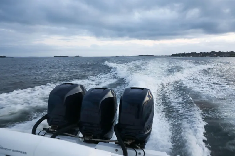 Slide: The Image of Midnight Express 37 boat, 2008 model, cruising on open water with three powerful engines. - 3