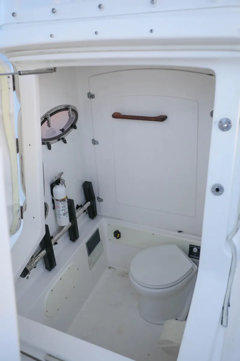 Slide: The Image of 2008 Midnight Express 37 boat interior bathroom with toilet and safety equipment. - 31