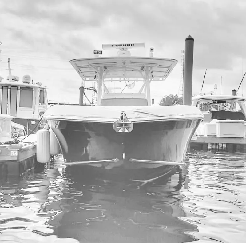 Slide: The Image of 2008 Midnight Express 37 boat docked in marina, front view, overcast sky. - 35