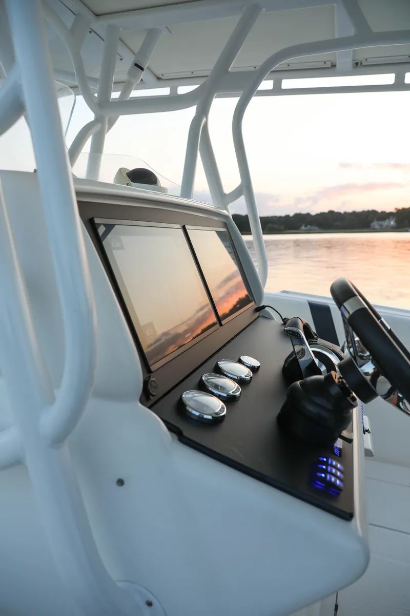 Slide: The Image of 2008 Midnight Express 37 boat dashboard at sunset on calm water. - 4