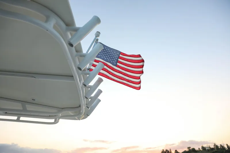Slide: The Image of American flag on 2008 Midnight Express 37 boat at sunset. - 8