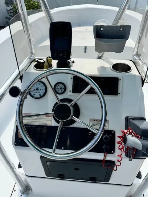 Slide: The Image of 2016 Sportsman Island Reef 19 Center Console dashboard with steering wheel and gauges. - 10