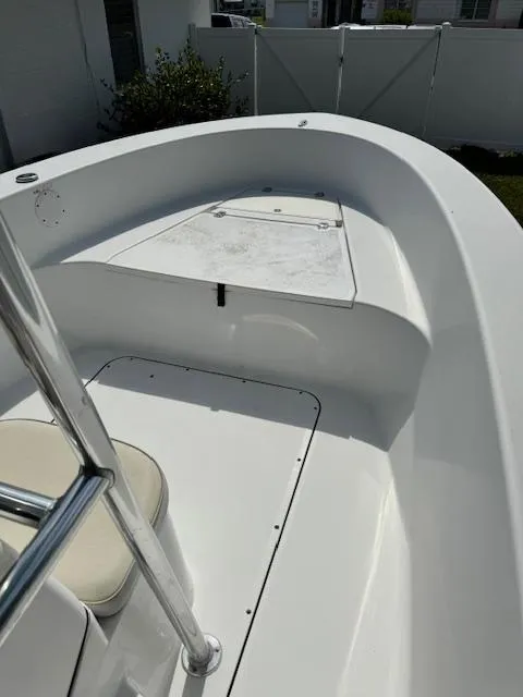 Slide: The Image of 2016 Sportsman Island Reef 19 Center Console boat interior, featuring sleek white design and seating. - 12
