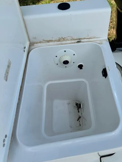 Slide: The Image of Open storage compartment on 2016 Sportsman Island Reef 19 Center Console boat. - 17